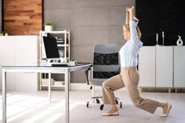 employee doing split squat exercise at desk