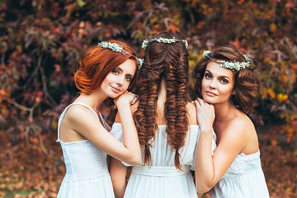 three beautiful bride on a background of autumn forest